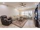Bright and open living room with tile flooring, recessed lighting, and a comfortable seating arrangement with an entertainment center at 103 Colony Point Dr, Punta Gorda, FL 33950