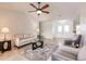 Neutral-toned living room with tile floors, modern furnishings, and a view of the home's entrance and dining area at 103 Colony Point Dr, Punta Gorda, FL 33950