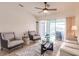Comfortable living room with neutral décor, tile floors, and sliding glass doors providing natural light and scenic views at 103 Colony Point Dr, Punta Gorda, FL 33950