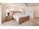 Main bedroom featuring a ceiling fan, neutral carpet, and adjacent tiled area at 103 Colony Point Dr, Punta Gorda, FL 33950