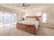 Bright main bedroom with large windows and a sliding glass door to the pool area at 103 Colony Point Dr, Punta Gorda, FL 33950