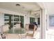View of screened in lanai with outdoor seating and ceiling fans at 103 Colony Point Dr, Punta Gorda, FL 33950