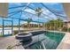 Enclosed pool and spa overlooking a serene lake, offering a private and relaxing outdoor oasis at 103 Colony Point Dr, Punta Gorda, FL 33950