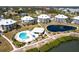 Wide aerial view of a community with waterfront views, a pool, and serene pond at 11000 Placida Rd # 1501, Placida, FL 33946
