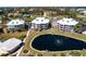 Wide aerial view of lovely neighborhood, featuring a pond, pool, and beautiful condos at 11000 Placida Rd # 1501, Placida, FL 33946