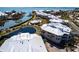 Aerial view of community featuring condos, a pond, a pool and boat dock access at 11000 Placida Rd # 1501, Placida, FL 33946