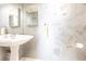 Charming powder room with pedestal sink, decorative wall art and soft lighting at 11000 Placida Rd # 1501, Placida, FL 33946