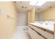 Bathroom featuring a shower-tub combo, single vanity, and yellow walls at 11000 Placida Rd # 1501, Placida, FL 33946