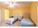 Bright bedroom with twin beds, ceiling fan, yellow walls and closet at 11000 Placida Rd # 1501, Placida, FL 33946