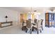 Bright dining area featuring a round glass table with wicker chairs, and chandelier at 11000 Placida Rd # 1501, Placida, FL 33946