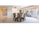 Open dining room featuring a round glass table, wicker chairs and a decorative chandelier at 11000 Placida Rd # 1501, Placida, FL 33946