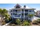 Beautiful condo with multiple floors, white trim, and lush tropical landscaping at 11000 Placida Rd # 1501, Placida, FL 33946
