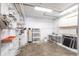 Storage and mechanical area in garage with shelving, water conditioner and utility sink at 11000 Placida Rd # 1501, Placida, FL 33946
