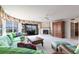 Bright living room with a fireplace, patterned furniture, and access to screened outdoor patio at 11000 Placida Rd # 1501, Placida, FL 33946