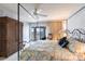 Comfortable primary bedroom featuring a four-poster bed, neutral walls, balcony access and natural light at 11000 Placida Rd # 1501, Placida, FL 33946