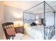 Comfortable primary bedroom featuring a four-poster bed, neutral walls, and warm lamps at 11000 Placida Rd # 1501, Placida, FL 33946