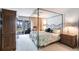 Comfortable primary bedroom featuring a four-poster bed, neutral walls, and balcony access at 11000 Placida Rd # 1501, Placida, FL 33946
