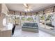 Bright sunroom features tiled floors, a ceiling fan, and wall-to-wall windows with tropical views at 11000 Placida Rd # 1501, Placida, FL 33946