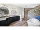 Bathroom featuring double vanity, modern fixtures, soaking tub and enclosed shower at 1111 San Mateo Dr, Punta Gorda, FL 33950