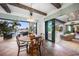 Dining area featuring views of canal and backyard patio access, terra cotta floors and wood beam ceilings at 1111 San Mateo Dr, Punta Gorda, FL 33950