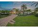 Striking home with a red-tiled roof and well-manicured lawn, complemented by beautiful palm trees at 1111 San Mateo Dr, Punta Gorda, FL 33950