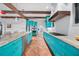 Large open kitchen with center island, updated appliances, custom blue cabinetry, and terra cotta floors at 1111 San Mateo Dr, Punta Gorda, FL 33950