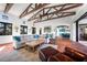 Bright living room with exposed beams, comfortable seating, and seamless access to the outdoors at 1111 San Mateo Dr, Punta Gorda, FL 33950
