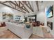 Spacious living room with exposed beams, a fireplace, and large windows, creating a warm and inviting atmosphere at 1111 San Mateo Dr, Punta Gorda, FL 33950