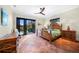 Bright main bedroom features a ceiling fan, tile floors and lanai access at 1111 San Mateo Dr, Punta Gorda, FL 33950