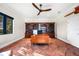 Spacious office with custom shelving, natural lighting, and terra cotta flooring throughout at 1111 San Mateo Dr, Punta Gorda, FL 33950