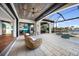 Outdoor patio and pool area with waterfront views and a partial view of the kitchen through sliding glass doors at 1111 San Mateo Dr, Punta Gorda, FL 33950