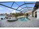 A luxurious screened-in pool and spa overlook a canal with boat dock, perfect for waterfront living at 1111 San Mateo Dr, Punta Gorda, FL 33950