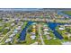 Stunning aerial perspective showcasing a waterfront property with direct access to the open water and surrounding neighborhood at 131 Buckeye Nw Ave, Port Charlotte, FL 33952