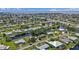 Aerial view showcasing a community with waterfront access and lush landscaping, in a desirable residential location at 131 Buckeye Nw Ave, Port Charlotte, FL 33952