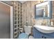 Charming bathroom showcasing glass block shower, rustic wood wall, and blue vanity at 131 Buckeye Nw Ave, Port Charlotte, FL 33952