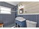 Stylish bathroom featuring blue patterned tile, white countertops, modern fixtures, and a framed mirror at 131 Buckeye Nw Ave, Port Charlotte, FL 33952