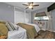 Comfortable bedroom with a ceiling fan, window, closet and wood-look floors at 131 Buckeye Nw Ave, Port Charlotte, FL 33952