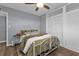 Cozy bedroom with hardwood floors, a comfortable bed, ceiling fan and white closet doors at 131 Buckeye Nw Ave, Port Charlotte, FL 33952