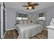 Cozy bedroom featuring a comfortable bed with a leaf-patterned ceiling fan at 131 Buckeye Nw Ave, Port Charlotte, FL 33952