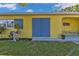 Charming exterior with unique architecture, blue shutters, and a quaint patio at 131 Buckeye Nw Ave, Port Charlotte, FL 33952