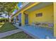 Charming front porch featuring colorful accents, seating, and a welcoming entrance at 131 Buckeye Nw Ave, Port Charlotte, FL 33952