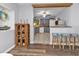 Open-concept kitchen featuring bar seating, stainless appliances, and stylish blue cabinetry at 131 Buckeye Nw Ave, Port Charlotte, FL 33952