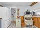 Bright kitchen area with laundry access, charming storage, and natural wood accents at 131 Buckeye Nw Ave, Port Charlotte, FL 33952