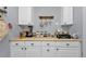 Charming kitchen with white cabinetry, modern appliances, and ample counter space for food preparation and storage at 131 Buckeye Nw Ave, Port Charlotte, FL 33952