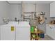 Bright laundry room with appliances, counter space, and shelving at 131 Buckeye Nw Ave, Port Charlotte, FL 33952
