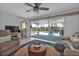 Cozy living room featuring bright natural light and outdoor views of the pool at 131 Buckeye Nw Ave, Port Charlotte, FL 33952