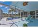 Inviting screened-in pool area with stylish patio furniture, perfect for outdoor entertaining and enjoying waterfront views at 131 Buckeye Nw Ave, Port Charlotte, FL 33952