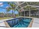 Refreshing in-ground pool surrounded by a screened enclosure, providing a private and serene space for relaxation and enjoyment at 131 Buckeye Nw Ave, Port Charlotte, FL 33952