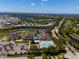 Community aerial view featuring a pool, tennis courts, clubhouse, and lush landscaping at 13352 Creekside Ln, Port Charlotte, FL 33953