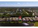 Aerial view of an attractive waterfront home in a tranquil neighborhood surrounded by lush greenery and a canal at 13352 Creekside Ln, Port Charlotte, FL 33953